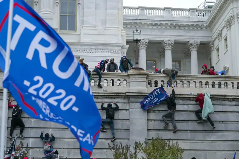 On January 6, 2021, rioters of Donald Trump scale the West Wall of the U.S. in Washington, D.C. - (AP Photo/Jose Luis Magana)